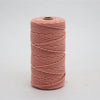 A spool of pink macrame cord, 3mm/4mm thickness, used for crafting.