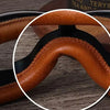 Close-up view of the brown leather foldable goggles showing the curved frame and padding.