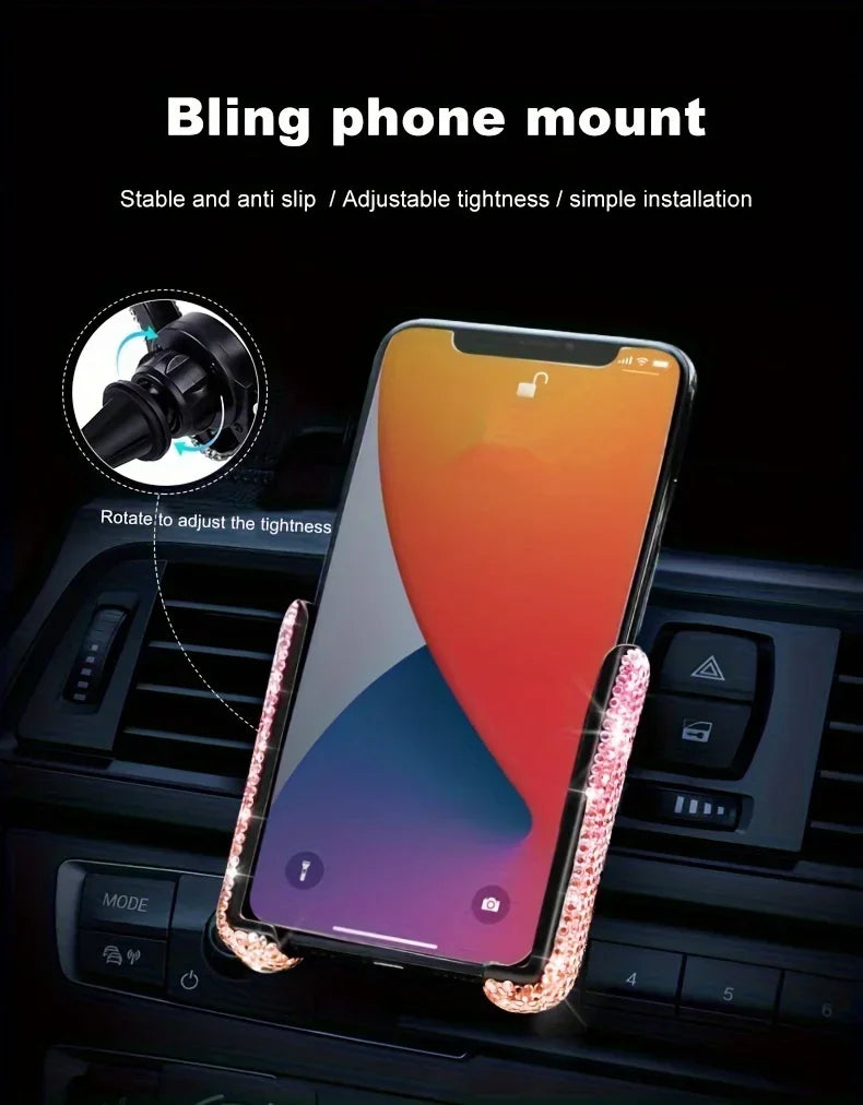 A clear phone mount with a pink crystal design is shown installed in a car air vent.