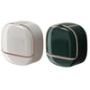 A modern, round soap holder with a white and dark green color scheme.