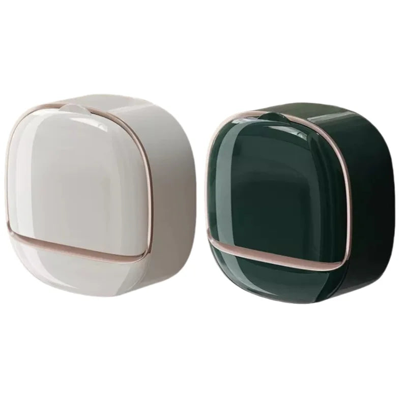 A modern, round soap holder with a white and dark green color scheme.