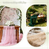 A display of a pink pearl beaded tulle table runner and floral decor for an outdoor wedding table.
