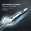A white cordless electric spin scrubber with a rotating brush head is shown cleaning stains on a dark surface.