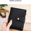 A hand holds a black compact RFID-blocking bi-fold wallet displaying its texture and closure.