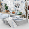 Stacks of marble self-adhesive wall stickers featuring blue veining used as 3D tile decals for kitchen and bathroom decor