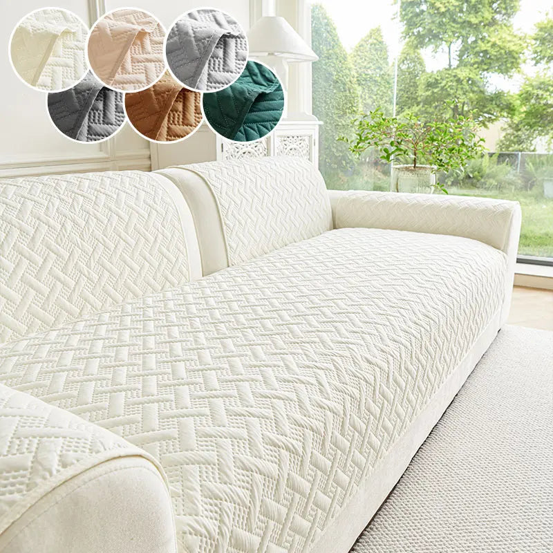 A white quilted anti-slip sofa cushion displayed on a light-colored sofa with various colored fabric swatches.
