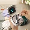 A hand holds an open compact magnetic sewing kit with various needles and thread colors displayed inside.