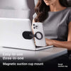 A woman uses a magnetic suction cup mount to hold a smartphone on a laptop.