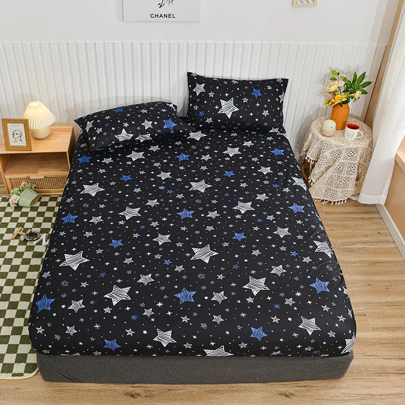 A black fitted bed sheet with a blue star pattern is displayed on a bed.