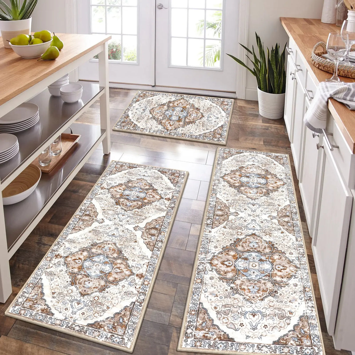 A long rectangular beige and brown patterned kitchen rug placed on a wooden floor.