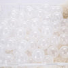 A white plastic basket filled with a large quantity of clear, round, bubble-like balls.