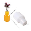 A silicone mold with a yellow glass bottle and various sized nozzles for candle and vase projects.