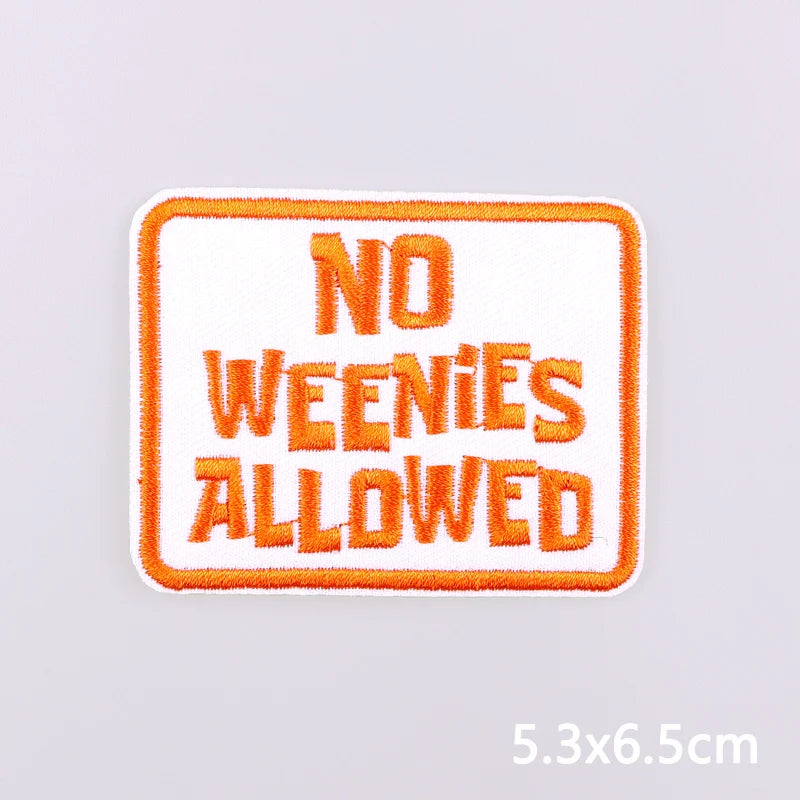 An embroidered patch with the text NO WEENIES ALLOWED in orange thread on a white background.
