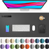 A computer monitor, a keyboard, a mouse, and various colored circles are displayed on a dark desk pad.