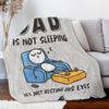A gray fleece throw blanket featuring a graphic of a sleeping dad resting his eyes.