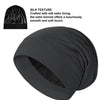 A black silk satin sleep bonnet shown in a rolled or gathered style.