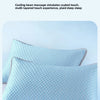 A light blue, textured pillow is shown resting on a white surface.