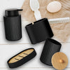 Matte black bathroom accessories set including a soap dispenser and holder on a wooden surface.
