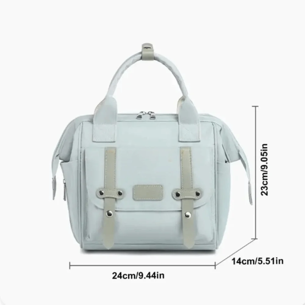 A light blue compact diaper backpack with a padded bottle holder and light beige straps.