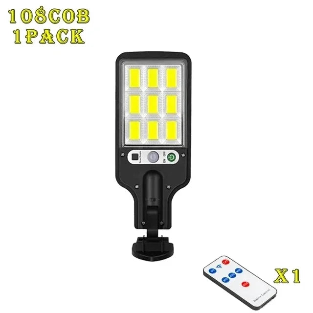 A black solar powered motion sensor flood light with a detachable panel and remote control.