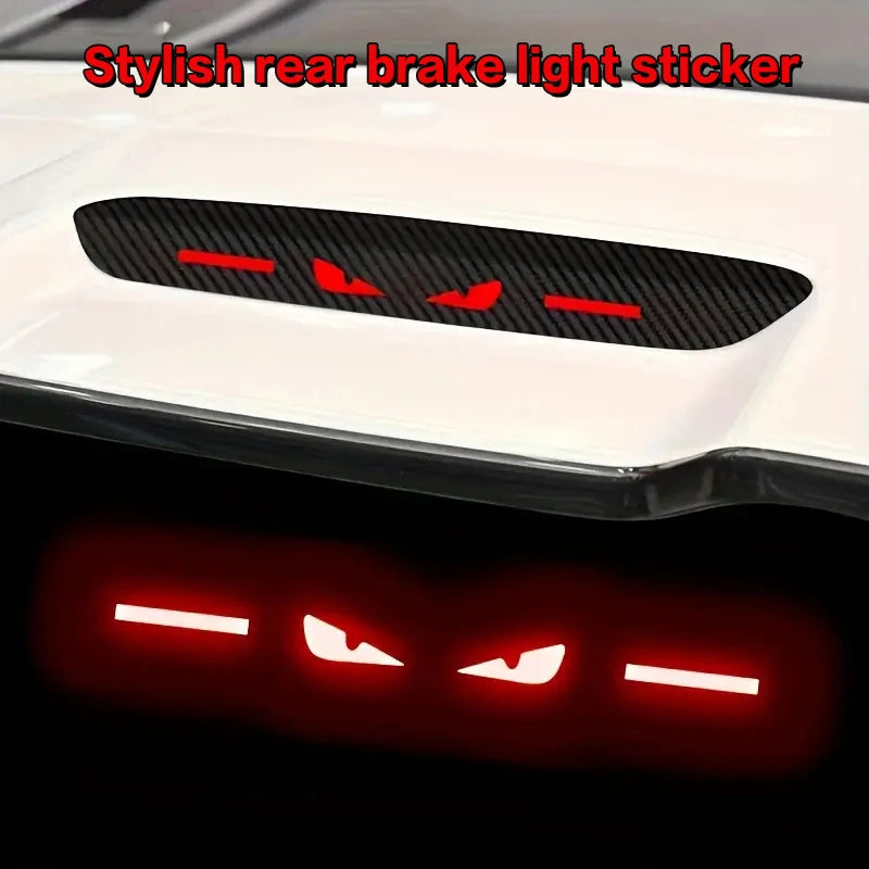 A black brake light sticker is shown mounted on a white car surface, with a red glow effect below.