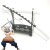 A miniature replica of a Demon Slayer sword is shown alongside a figure inspired by Tanjiro, featuring a black hilt and white
