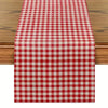 A red and white gingham table runner placed on a wooden table.