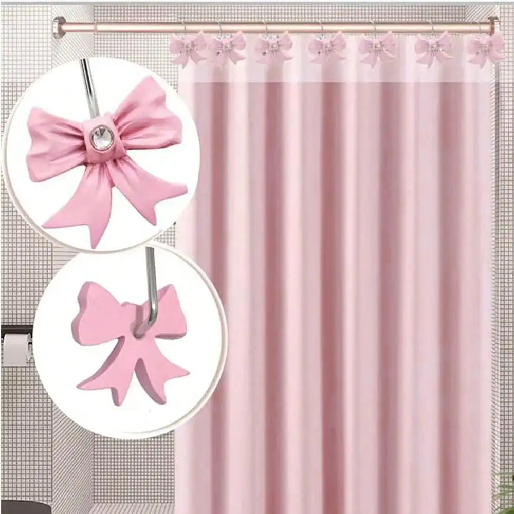 Set of twelve decorative pink bow tie shower curtain hooks with a silver ring.