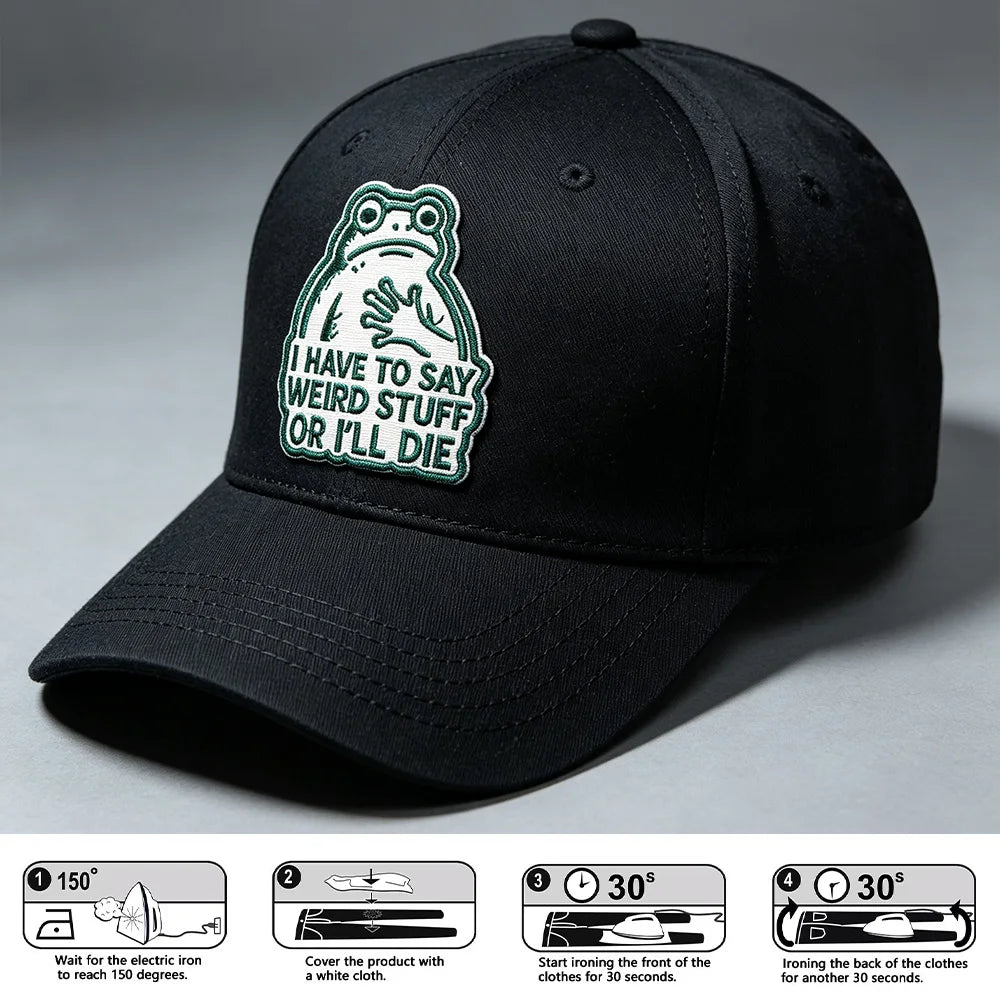 Black baseball cap with an embroidered frog patch that says I have to say weird stuff or I'll die