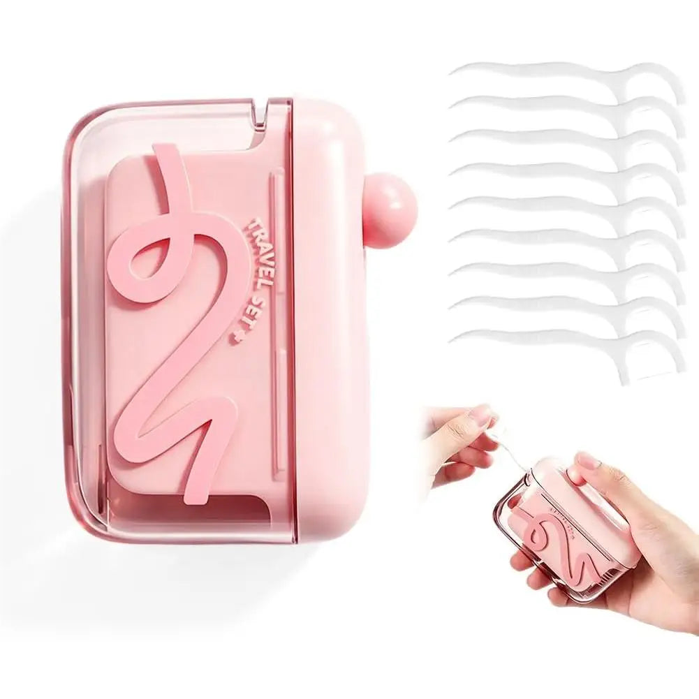 A pink portable automatic floss pick dispenser with a pop-up mechanism and a set of white floss picks.