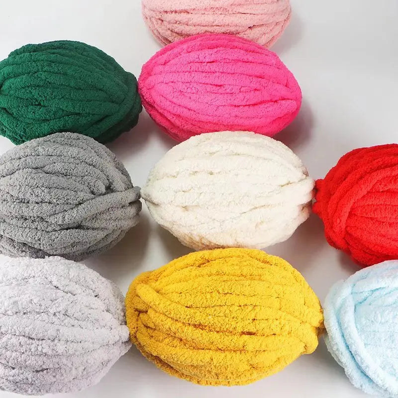 A collection of brightly colored and textured chenille yarn balls in shades of pink, green, gray, white, orange, and red.