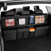 Interior view of a car showing a black foldable trunk organizer with various storage compartments and items.
