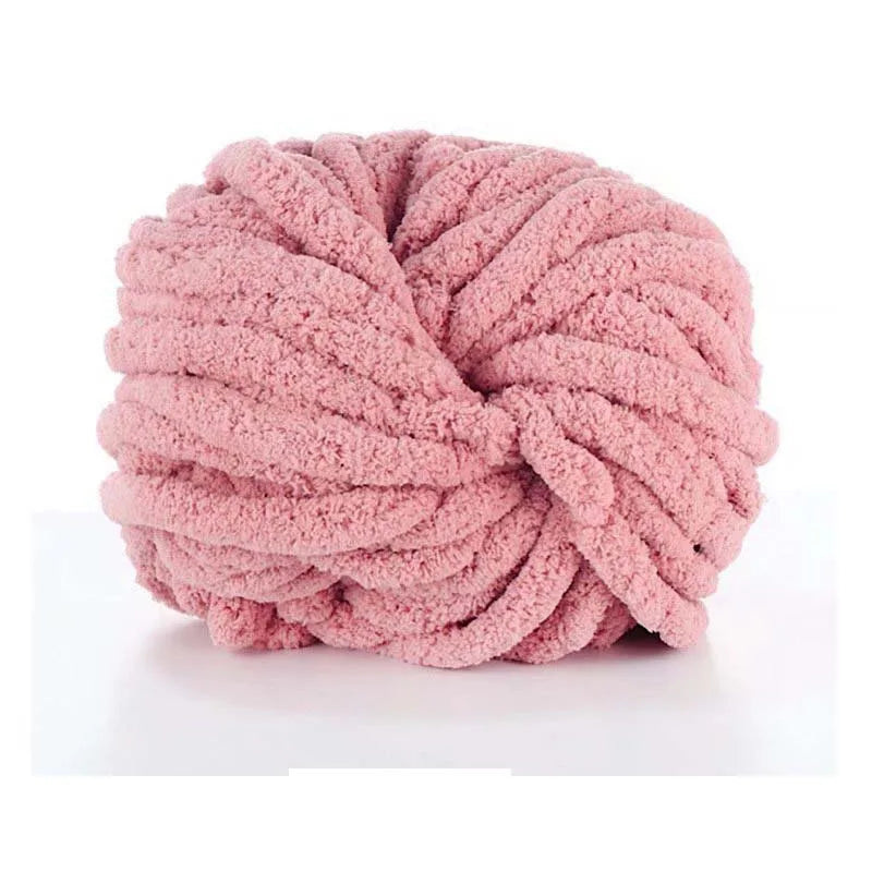 A ball of pink chunky acrylic yarn used for knitting and crochet projects.