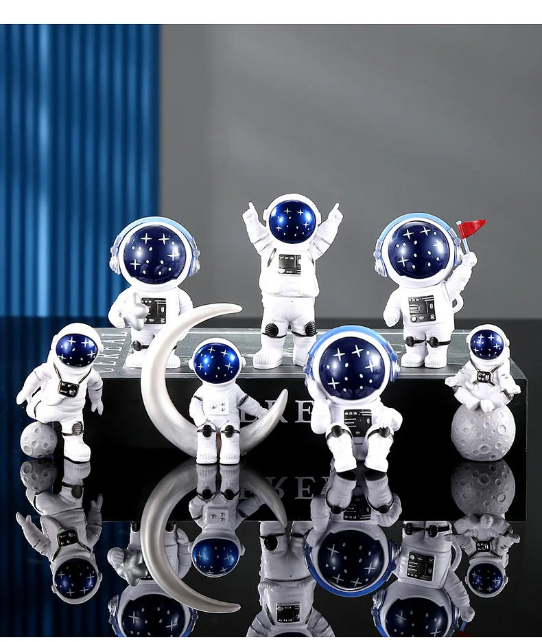 A collection of handcrafted astronaut figurine resin spacemen desk decor displayed on a black surface.