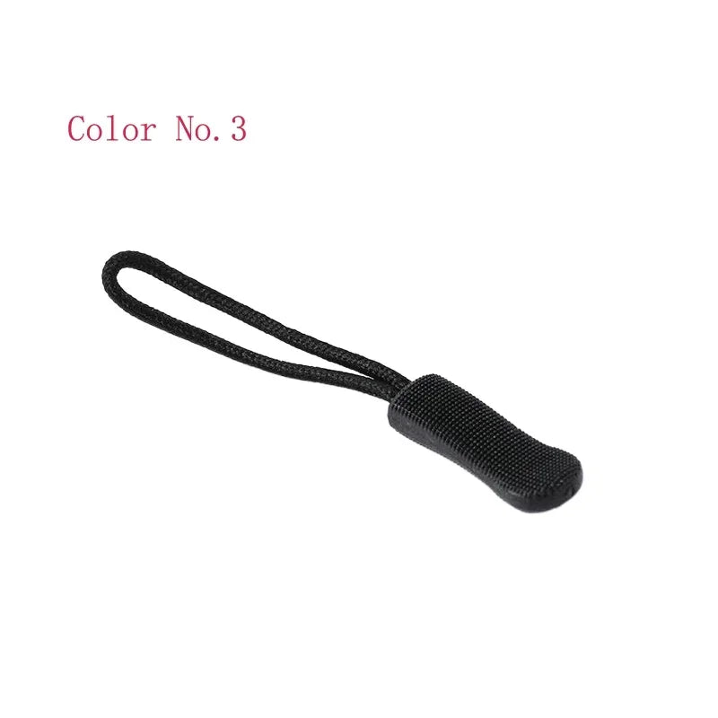 A black plastic zipper pull with a thin cord attached, labeled Color No. 3.