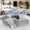 Stacks of blue and white marble self-adhesive wall stickers displayed in a modern kitchen setting.