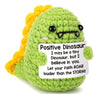 Handmade crochet dinosaur doll with yellow crest and a sign that says Positive Dinosaur I may be a tiny Dinosaur but I believ