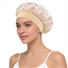 A woman wearing a light pink silk satin sleep bonnet with a wide elastic band.