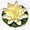 A lifelike floating lotus flower made of pale yellow petals resting on a dark green leaf.