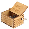 A wooden music box with a lid engraved 'LA VIE EN ROSE' and a crank mechanism.