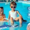 A child is holding a remote control shark toy that sprays water in a swimming pool.