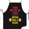 Black chef apron with red text that reads Kiss the Cook and Bring him a Beer