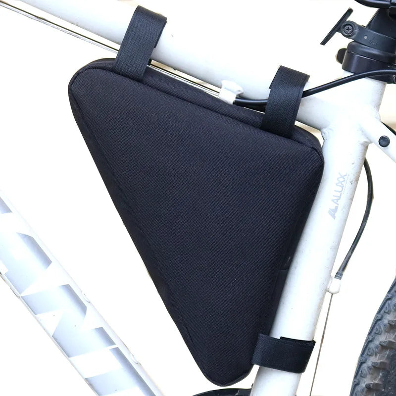 Black waterproof bike frame bag with velcro straps mounted on a white bicycle frame.
