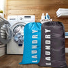 Two reusable laundry storage bags, one bright blue and one dark gray, are displayed next to a white washing machine.