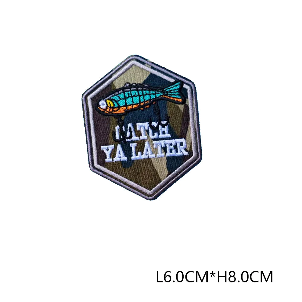 An embroidered patch featuring a brightly colored fish above the text YA LATER on a dark background.