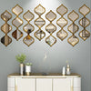 A wall featuring a decorative arrangement of gold-framed, Moroccan-inspired mirrors above a white cabinet.