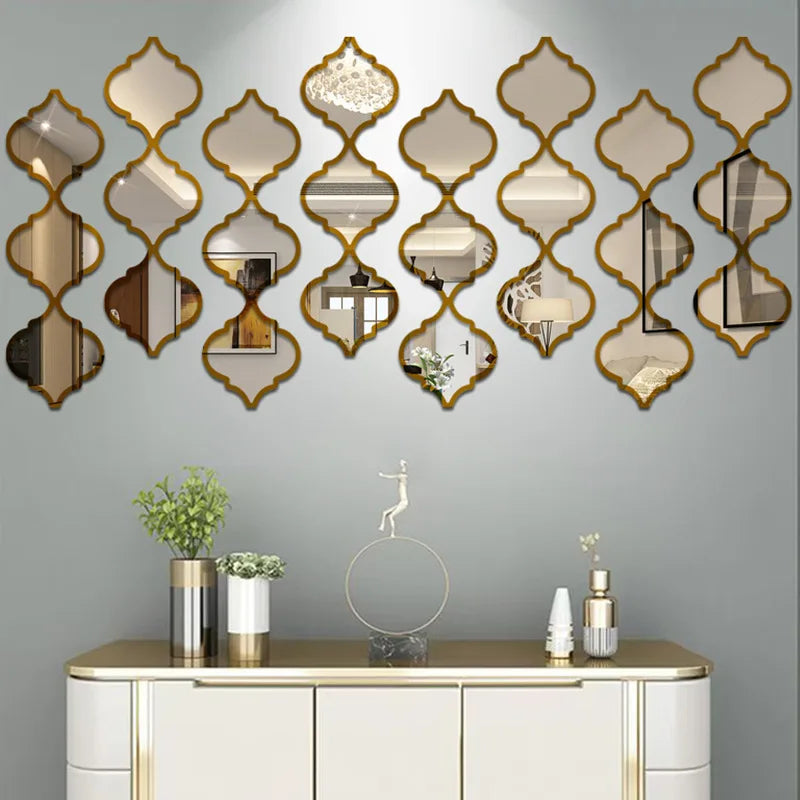 A wall featuring a decorative arrangement of gold-framed, Moroccan-inspired mirrors above a white cabinet.