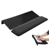 Black ergonomic acrylic keyboard stand with a memory foam wrist rest shown next to a hand typing on the keyboard.