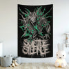 A black tapestry featuring a dark, monstrous design with green accents and the text SUICIDE SILENCE in a distressed font.