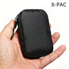 A hand is holding a black X-PAC compact EDC utility pouch.